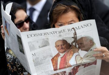 Жінка читає примірник ватиканської газети L'Osservatore Romano, фото REUTERS