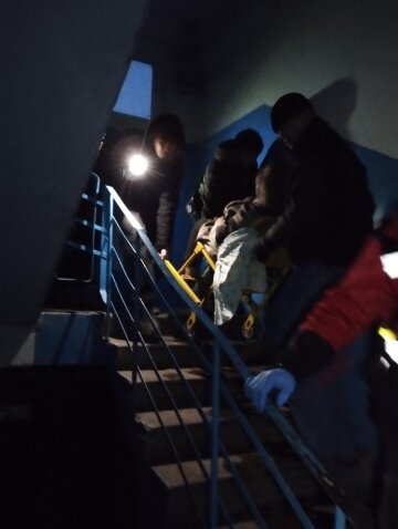 Люди спускаются в подъезде