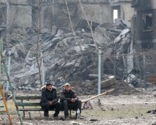 Українці навпроти зруйнованого будинку / фото: Ukrainian World Congress