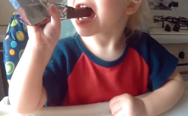 Ребенок ест шоколад, кадр из видео